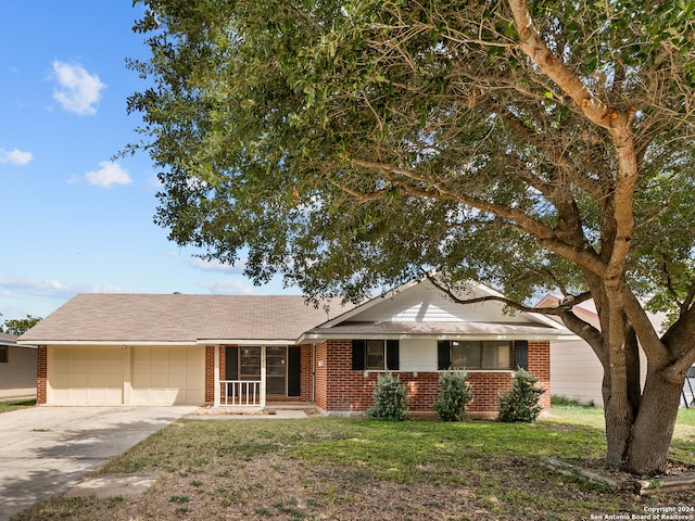 ranch-style house featuring a garage and a front lawn