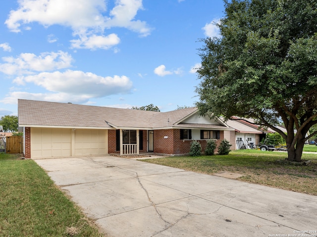 single story home featuring a garage and a front yard