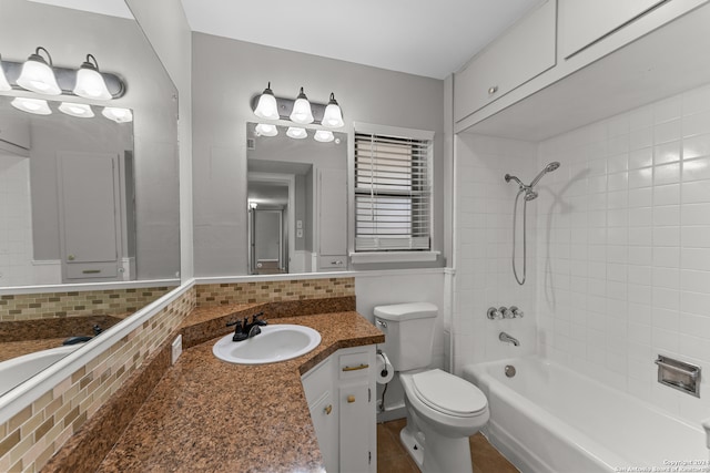 full bathroom featuring backsplash, vanity, toilet, and tiled shower / bath combo