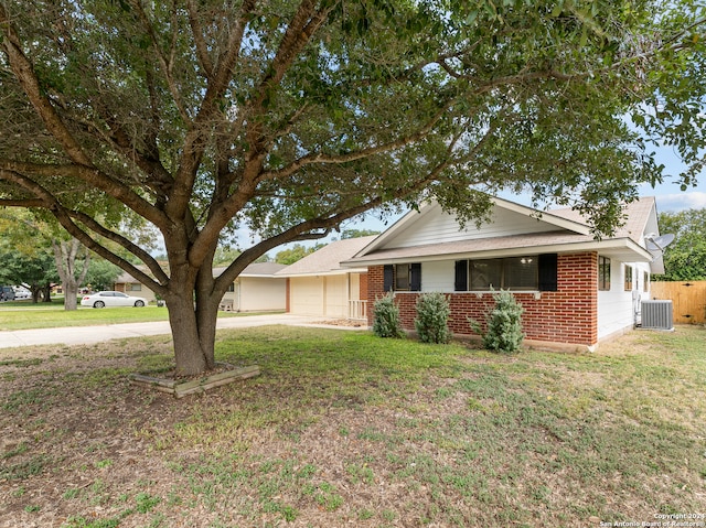 ranch-style house featuring a front yard, a garage, and central AC