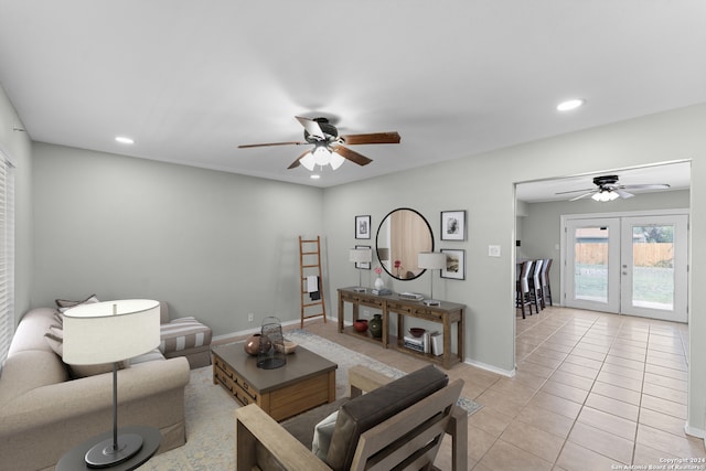 tiled living room with ceiling fan and french doors