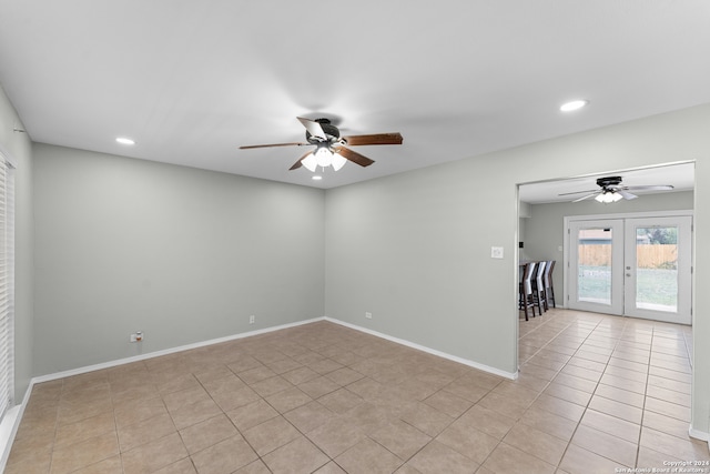 unfurnished room with ceiling fan, light tile patterned flooring, and french doors