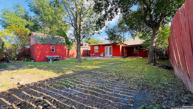 view of yard featuring a storage shed and a patio