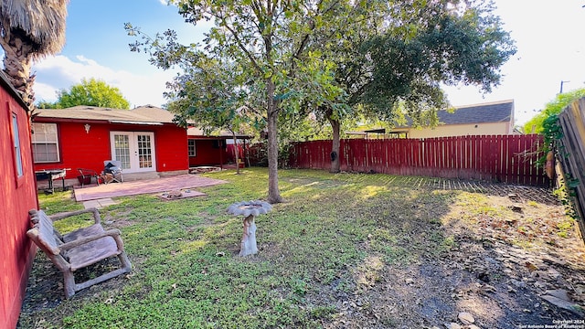 view of yard featuring french doors and a patio area