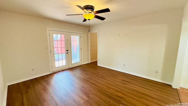 spare room featuring dark hardwood / wood-style flooring, ceiling fan, and french doors