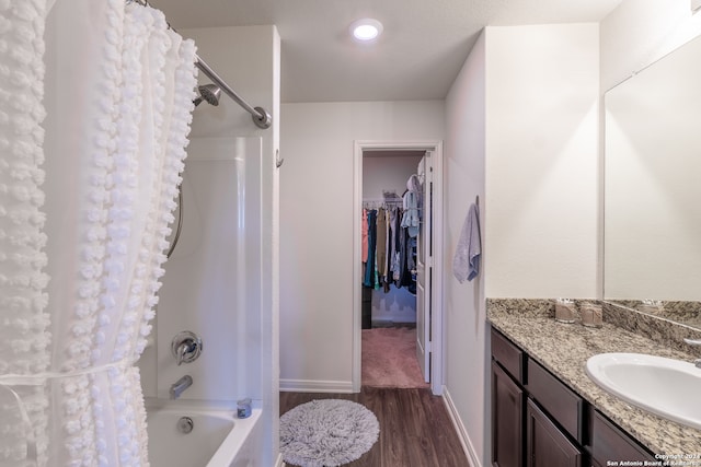 bathroom featuring shower / bathtub combination with curtain, wood-type flooring, and vanity