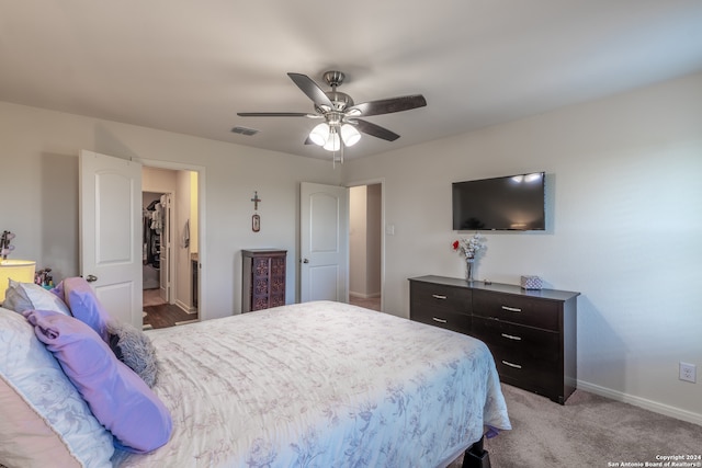 bedroom with ceiling fan and light colored carpet