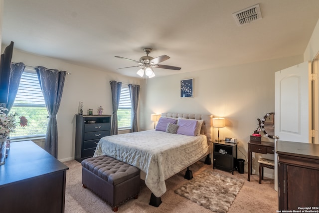 bedroom with ceiling fan and light colored carpet