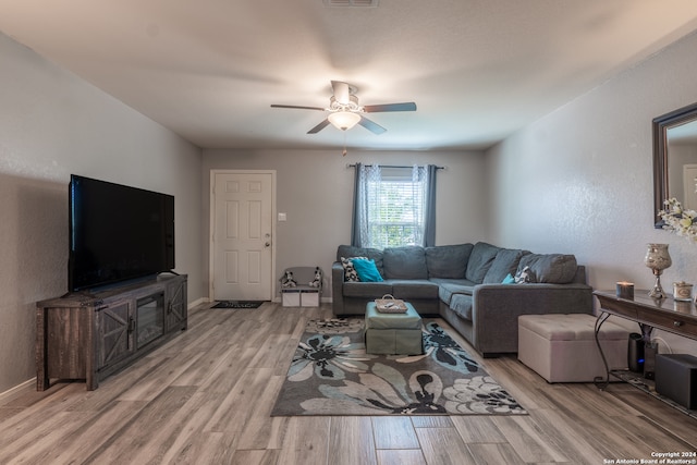 living room with light wood-type flooring and ceiling fan