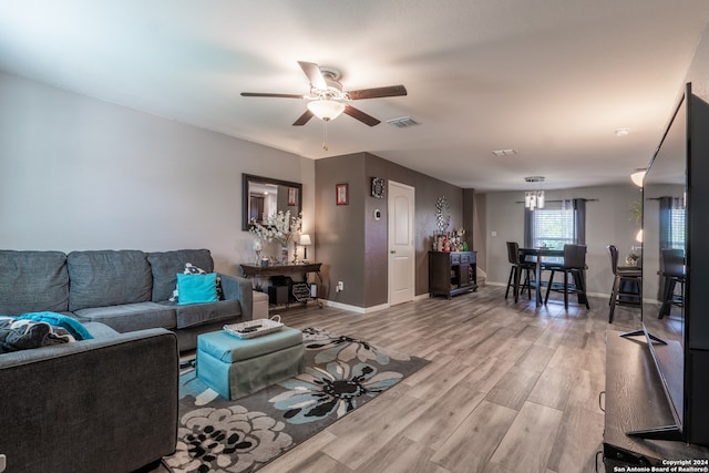 living room featuring hardwood / wood-style floors and ceiling fan