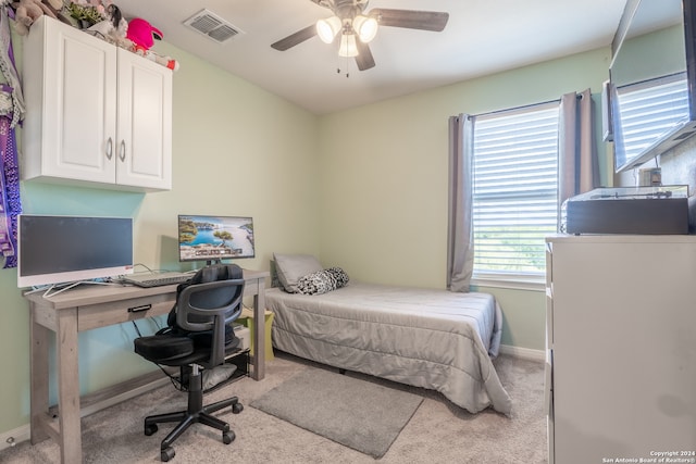 bedroom featuring light carpet and ceiling fan