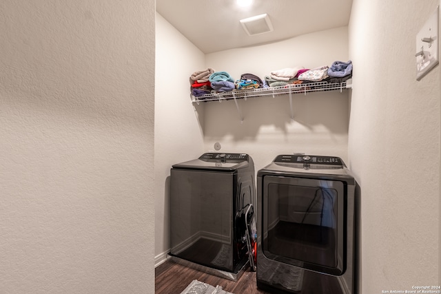 washroom featuring washer and clothes dryer and dark hardwood / wood-style flooring