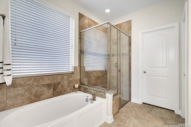 bathroom featuring shower with separate bathtub