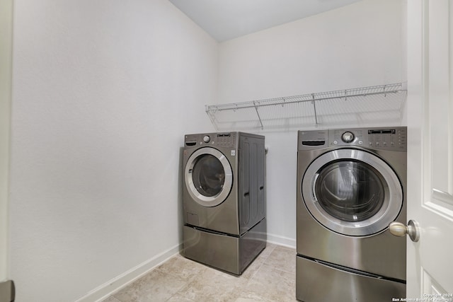 laundry area featuring light tile patterned floors and separate washer and dryer