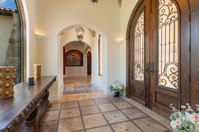 entrance foyer featuring a high ceiling and french doors