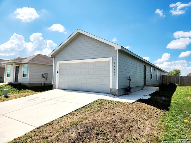 view of property exterior with a yard and a garage