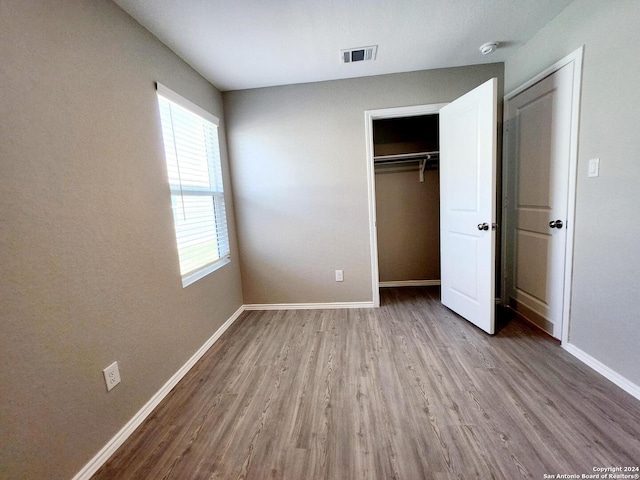 unfurnished bedroom featuring light wood-type flooring