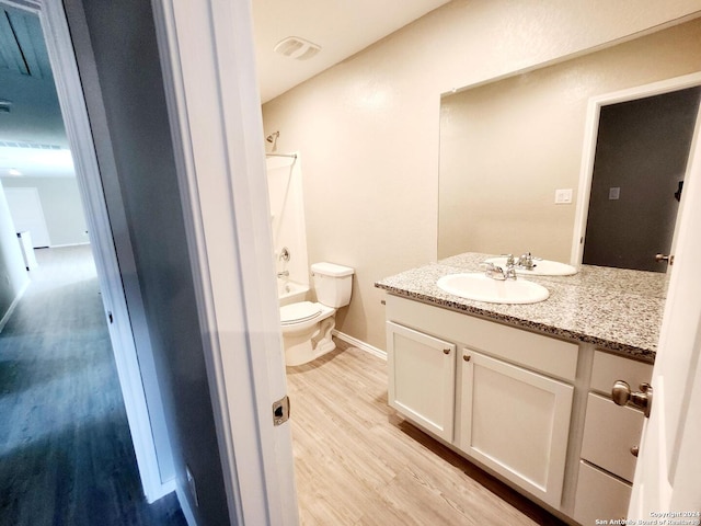 full bathroom featuring wood-type flooring, vanity, toilet, and bathing tub / shower combination