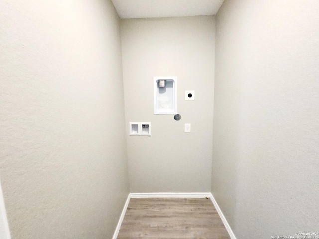 laundry area with hookup for a washing machine, hardwood / wood-style flooring, and electric dryer hookup