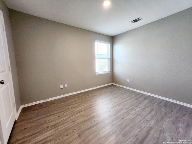 empty room featuring hardwood / wood-style flooring