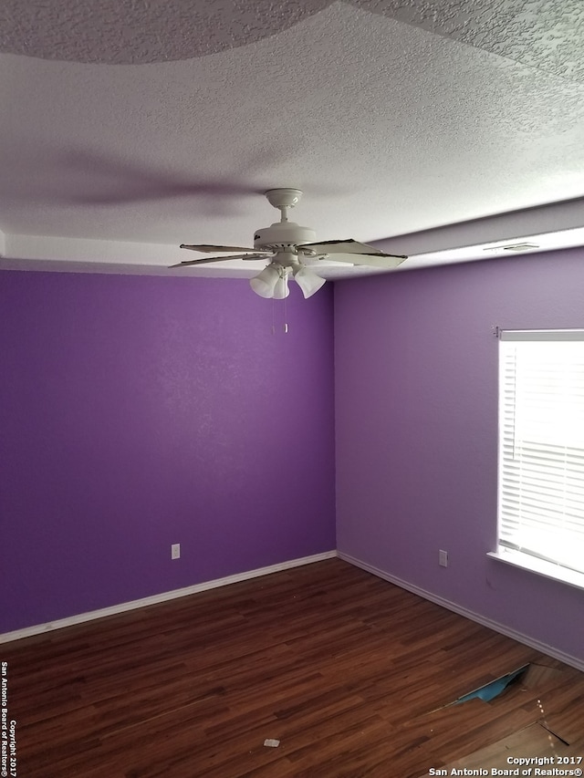 spare room featuring a textured ceiling, hardwood / wood-style flooring, and ceiling fan