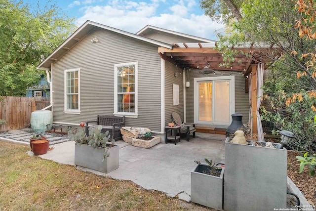 back of property with a pergola and a patio area