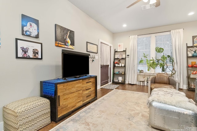 living area with dark hardwood / wood-style floors and ceiling fan