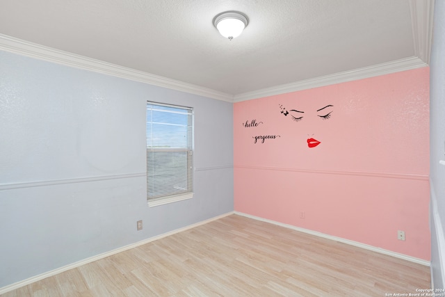 unfurnished room featuring light wood-type flooring and crown molding