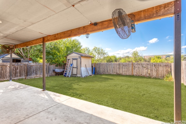 view of yard featuring a storage shed and a patio