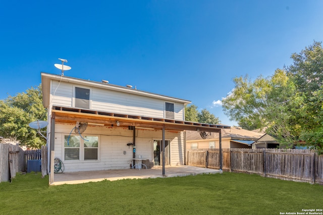 rear view of property with a lawn and a patio area