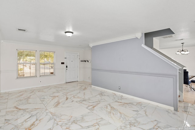 entrance foyer with a notable chandelier and ornamental molding