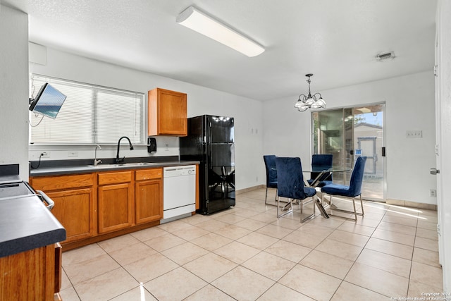 kitchen featuring a wealth of natural light, white dishwasher, hanging light fixtures, and sink