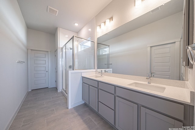 10280 Bartenheim Dr, Schertz, TX 78154 - bathroom with double vanity, a shower stall, and baseboards