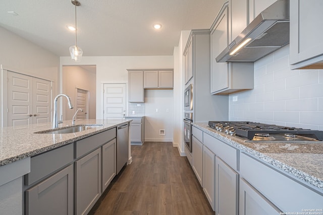 10280 Bartenheim Dr, Schertz, TX 78154 - kitchen with appliances with stainless steel finishes, exhaust hood, gray cabinets, a sink, and light stone countertops