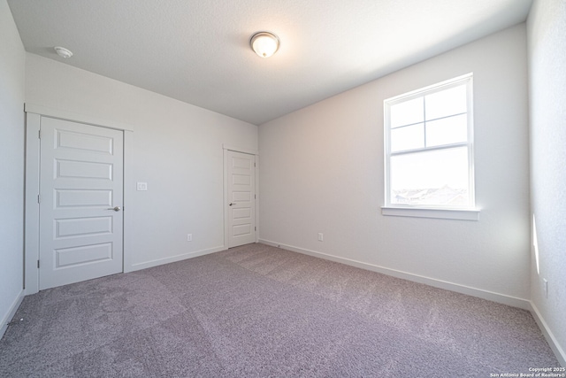 10280 Bartenheim Dr, Schertz, TX 78154 - spare room featuring carpet, baseboards, and a smoke detector