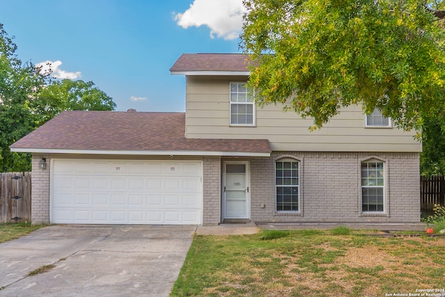 view of front of house with a garage and a front lawn