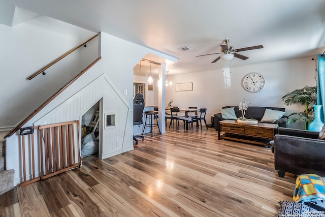 living room featuring ceiling fan and hardwood / wood-style flooring