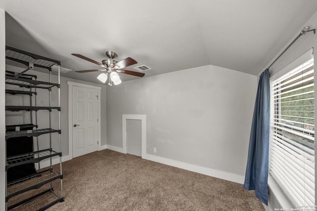 unfurnished bedroom featuring carpet floors, lofted ceiling, and ceiling fan