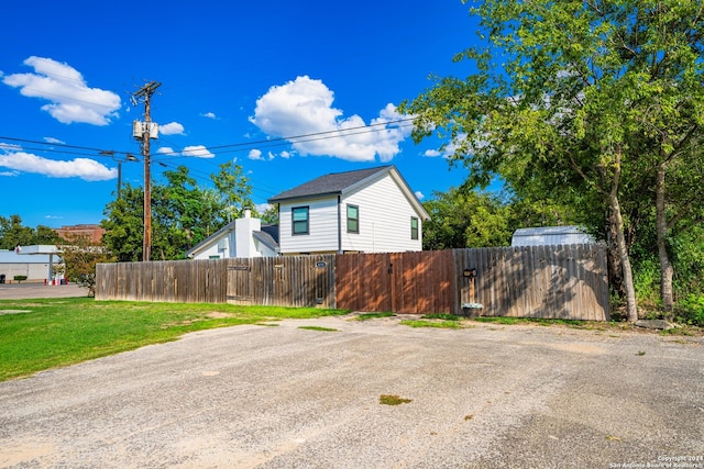 view of side of property with a lawn