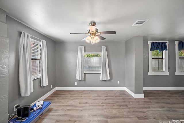 spare room featuring ceiling fan and light hardwood / wood-style floors