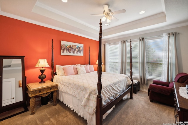 carpeted bedroom featuring crown molding, a tray ceiling, and ceiling fan