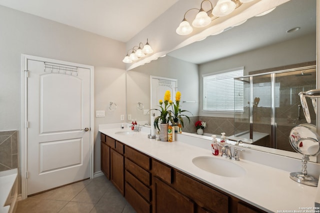 bathroom with tile patterned flooring, vanity, and separate shower and tub