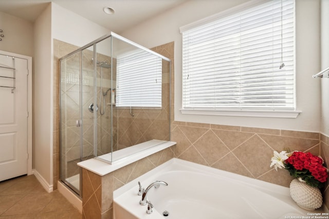 bathroom with plus walk in shower, plenty of natural light, and tile patterned floors