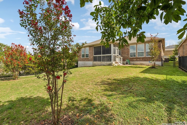 exterior space with a sunroom and a front yard