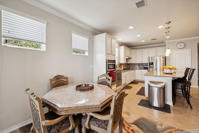 tiled dining area with crown molding