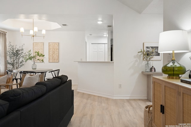 living room featuring light hardwood / wood-style floors and a chandelier