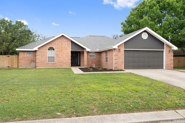 ranch-style home featuring a front yard and a garage