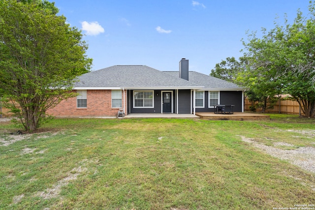 rear view of property featuring a patio and a yard