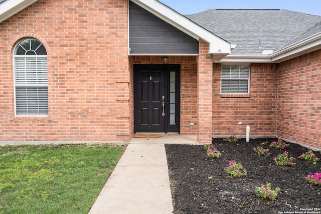 doorway to property featuring a lawn