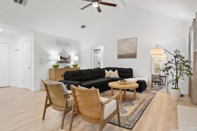 living room featuring high vaulted ceiling, beam ceiling, ceiling fan, and light hardwood / wood-style flooring